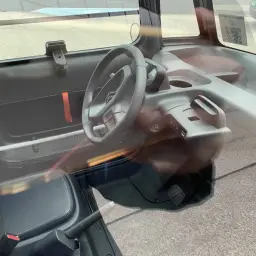 Wnętrze Citroen Ami: kierownica, siedzenie, deska rozdzielcza z uchwytem i panelem sterowania.