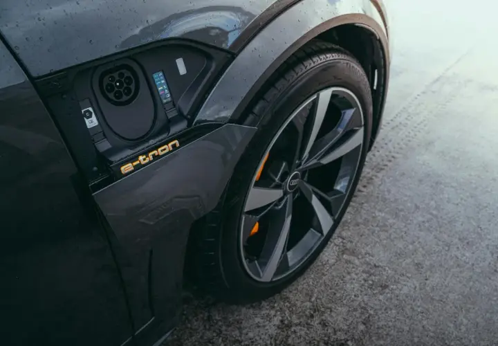 Zbliżenie na port ładowania i felgę Audi A3 e-tron. Elektryczna mobilność w nowoczesnym wydaniu.